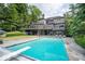 Luxury home featuring a large inground pool, stone patio, and beautiful backyard, perfect for outdoor enjoyment at 11715 Landings Dr, Indianapolis, IN 46256