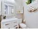 Modern bathroom with marble countertops, decorative mirror, and stylish fixtures at 13217 E 131St St, Fishers, IN 46037