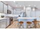 Modern kitchen featuring stainless steel appliances, large island, and pendant lighting, set against light grey cabinetry at 13217 E 131St St, Fishers, IN 46037