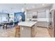 Open concept kitchen with stainless steel appliances and breakfast bar adjacent to a dining area with a unique color accent wall at 13217 E 131St St, Fishers, IN 46037