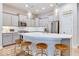 Modern kitchen featuring stainless steel appliances, a curved island, pendant lighting, and light grey cabinetry and countertops at 13217 E 131St St, Fishers, IN 46037