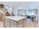 Bright and modern kitchen showcasing a large island, stainless steel appliances, and hardwood floors throughout the living space at 13217 E 131St St, Fishers, IN 46037