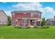 Exterior shot shows the backyard with covered patio and outdoor furniture at 14075 Knightstown E Dr, Carmel, IN 46033