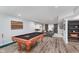 Finished basement featuring a pool table, sofa, and barn doors at 14075 Knightstown E Dr, Carmel, IN 46033