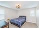 A cozy bedroom with neutral walls, carpet, modern ceiling fan, and a desk at 14075 Knightstown E Dr, Carmel, IN 46033