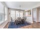 Charming dining room with wood table, black chairs, blue rug, and bright natural lighting at 14075 Knightstown E Dr, Carmel, IN 46033