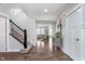 Bright entryway with wood floors, staircase and view into the living room at 14075 Knightstown E Dr, Carmel, IN 46033