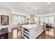 Open concept kitchen features a center island with bar seating and pendant lighting at 14075 Knightstown E Dr, Carmel, IN 46033