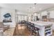 Open-concept kitchen featuring stainless steel appliances, island seating, and a view of the dining area at 14075 Knightstown E Dr, Carmel, IN 46033