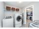 Well-lit laundry room offering modern washer and dryer, and shelving for storage at 14075 Knightstown E Dr, Carmel, IN 46033