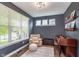 A well-lit space with a comfortable chair, piano and ample natural light streaming through a large window at 14075 Knightstown E Dr, Carmel, IN 46033