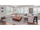 The bright living room features a large sectional couch, layered rug and plenty of natural light at 14075 Knightstown E Dr, Carmel, IN 46033