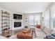 Comfortable living room area with fireplace, plush sectional couch, and large windows at 14075 Knightstown E Dr, Carmel, IN 46033