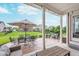 Covered patio with multiple seating areas overlooks landscaped backyard at 14075 Knightstown E Dr, Carmel, IN 46033