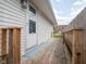 Exterior porch featuring a wooden railing, door with window and gray flooring at 1415 Lawton Ave, Indianapolis, IN 46203