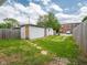 Spacious backyard featuring detached garages, stone pathways and grassy area at 1415 Lawton Ave, Indianapolis, IN 46203