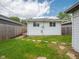 View of the house's rear exterior and backyard featuring a stone path and a small landing at 1415 Lawton Ave, Indianapolis, IN 46203