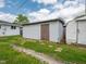 Backyard featuring a detached garage, shed, and grassy areas at 1415 Lawton Ave, Indianapolis, IN 46203