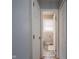 Hallway view into bathroom with patterned floor, bright window, and white door at 1415 Lawton Ave, Indianapolis, IN 46203