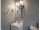 Bathroom featuring a sleek, white vanity, modern faucet and mirror, and neutral wall paint at 1415 Lawton Ave, Indianapolis, IN 46203