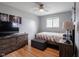 Comfortable bedroom featuring a ceiling fan, natural light, and hardwood floors at 1415 Lawton Ave, Indianapolis, IN 46203
