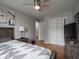 Relaxing bedroom featuring a ceiling fan, hardwood floors, and a spacious closet at 1415 Lawton Ave, Indianapolis, IN 46203