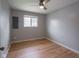 Clean and spacious bedroom features a ceiling fan and hardwood floors at 1415 Lawton Ave, Indianapolis, IN 46203