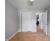 A spacious bedroom with sliding door closet, ceiling fan, and hardwood floors at 1415 Lawton Ave, Indianapolis, IN 46203