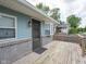 A well-maintained porch with brick accents, offering a view of the exterior and a glimpse of the neighborhood at 1415 Lawton Ave, Indianapolis, IN 46203