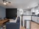 Bright open concept living area connecting to a kitchen with sleek countertops and stainless steel appliances at 1415 Lawton Ave, Indianapolis, IN 46203