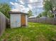 Backyard shot of shed, surrounded by grass, and wooden fence at 1415 Lawton Ave, Indianapolis, IN 46203