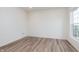 Bright bedroom features wood-look floors, natural light, and neutral paint at 14515 Hanford Ln, Carmel, IN 46074