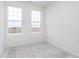 Bedroom with plush neutral carpet and two windows, providing a comfortable and inviting atmosphere at 14515 Hanford Ln, Carmel, IN 46074