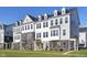 Modern townhome showcases a brick and siding exterior, dormer windows, and lush green lawn at 14515 Hanford Ln, Carmel, IN 46074