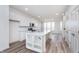 Bright kitchen features white cabinets, stainless steel appliances, a center island, and hardwood floors at 14515 Hanford Ln, Carmel, IN 46074