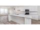 Spacious kitchen features a center island, white cabinets, stainless steel appliances and hardwood floors at 14515 Hanford Ln, Carmel, IN 46074