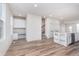 Open-concept living room with desk, center island, stainless steel dishwasher and hardwood floors at 14515 Hanford Ln, Carmel, IN 46074