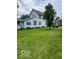Spacious backyard with well-manicured lawn, mature trees, and landscaping around perimeter at 1517 S Reisner St, Indianapolis, IN 46221