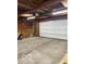Spacious garage interior with concrete floors, overhead door, and ample storage space at 1517 S Reisner St, Indianapolis, IN 46221