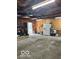 Spacious garage interior with concrete floors, ample storage space, and access door at 1517 S Reisner St, Indianapolis, IN 46221