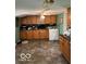 Spacious kitchen with wood cabinets, tiled floor, and modern appliances at 1517 S Reisner St, Indianapolis, IN 46221