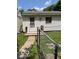 View of shed in backyard with single door and mature landscaping at 1517 S Reisner St, Indianapolis, IN 46221