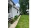 Landscaped yard with walkway, flowers, and mature trees at 1517 S Reisner St, Indianapolis, IN 46221