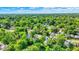 Aerial view displays homes nestled among abundant trees, illustrating a peaceful neighborhood and the property's location at 1523 E Mills Ave, Indianapolis, IN 46227