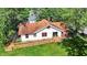 Aerial view of a home with a ramp, surrounded by lush trees, offering privacy at 1523 E Mills Ave, Indianapolis, IN 46227