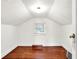 Attic featuring white walls, wooden floors, and natural light at 1523 E Mills Ave, Indianapolis, IN 46227