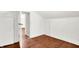 A bright attic space with hardwood floors, white walls, and an open doorway at 1523 E Mills Ave, Indianapolis, IN 46227