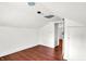 Attic featuring white walls, wooden floors, and natural light at 1523 E Mills Ave, Indianapolis, IN 46227