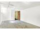 A bright unfinished basement with a window and an open doorway at 1523 E Mills Ave, Indianapolis, IN 46227