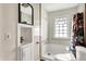 Bathroom featuring a shower-tub combo, a sink, a mirror, and a toilet at 1523 E Mills Ave, Indianapolis, IN 46227